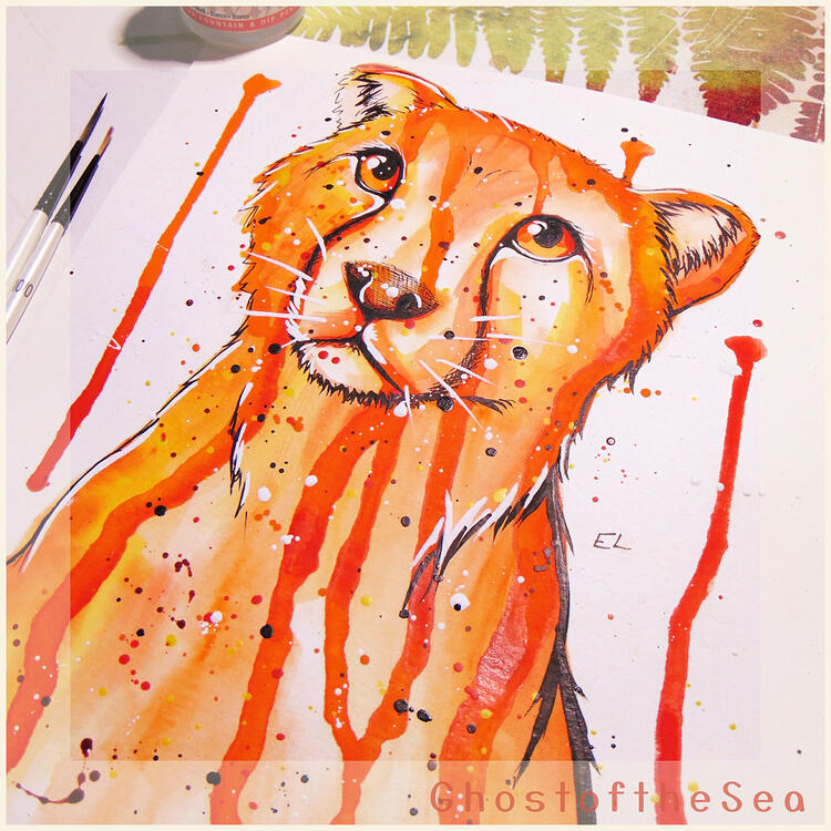 An A4 watercolour painting of a cheetah’s head and shoulders in bright gold and orange, with splatters and drips of paint around it.