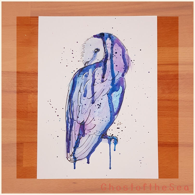 Photo of an A4 watercolour painting of a barn owl in blue and purple with drips and splatters of paint.